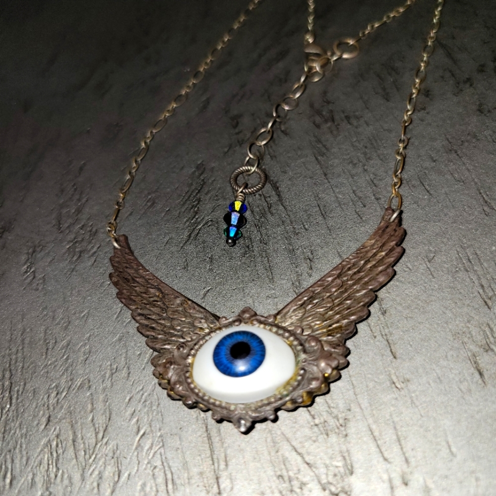Silver wing eye necklace